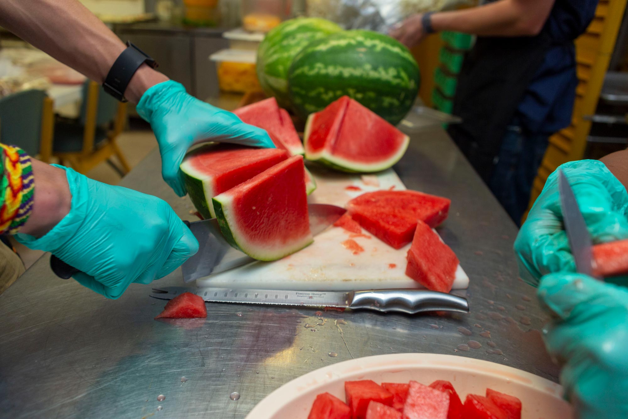 Watermelon being sliced for the lunch salad bar.